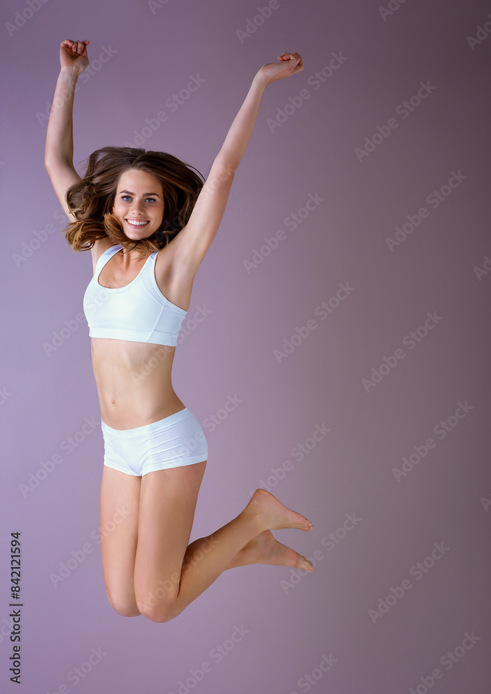 Happy woman, portrait and jump in studio with underwear for weight loss, diet or wellness on pink background. Active, excited face and slim model person for fitness, healthy body or energy mockup