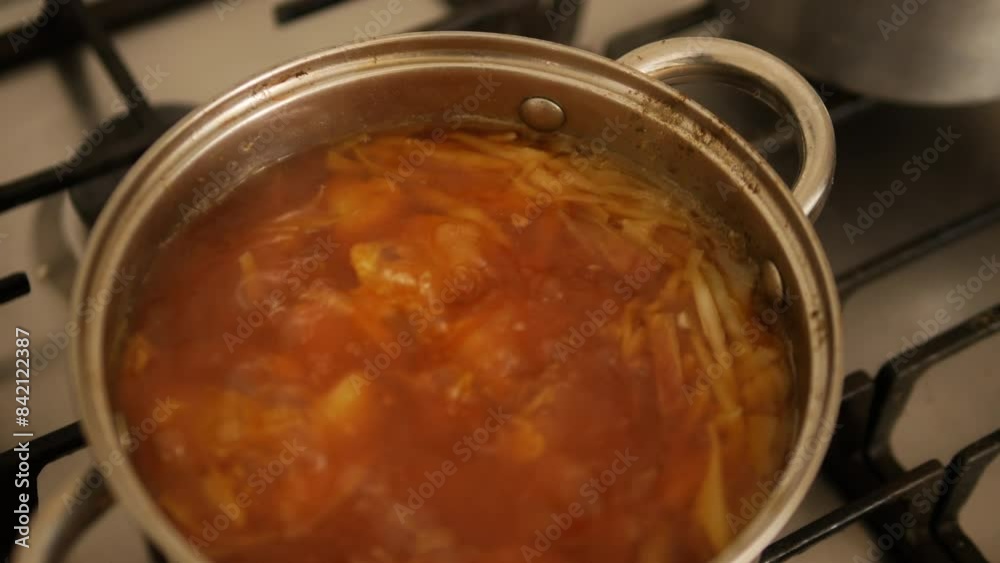 Bouillabaisse soup. Red soup with seafood, boiled in a saucepan. Cook traditional Ukrainian borscht on a gas stove.