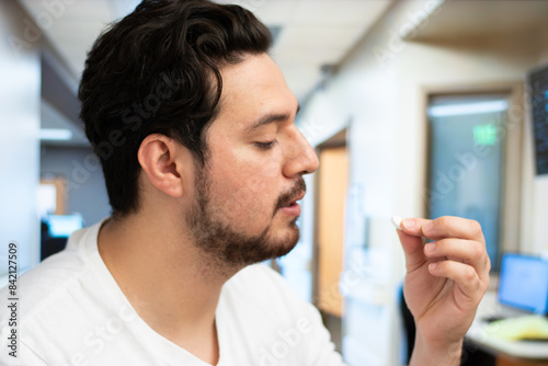 Close up of man taking a medicine pill in the hospital with copy space