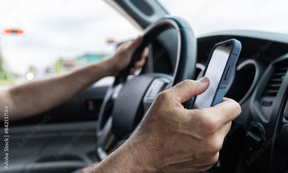 Man texting while driving horizontal shot Man texting while driving horizontal shot