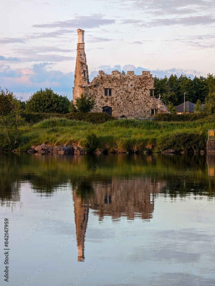 Terryland castle reflected in Corrib river at Galway city, Ireland, historical landmark background, wallpaper
