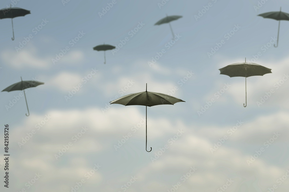 surreal moment of a group of black umbrellas flying in the sky among the clouds surreal moment of a group of black umbrellas flying in the sky among the clouds