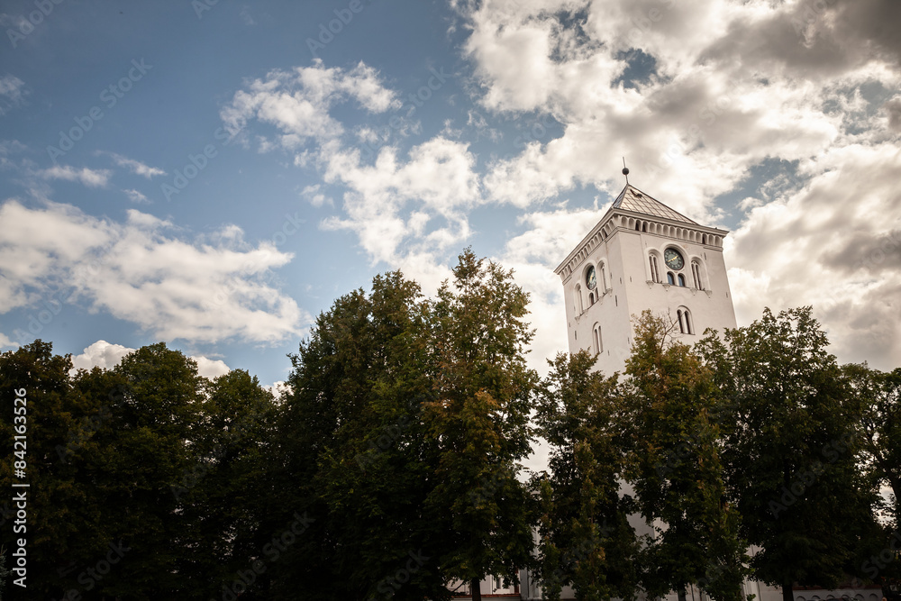 Fototapeta premium Jelgava saint trinity church tower on a cloudy afternoon in Jelgava, Latvia. jelgavas svetas trisvienibas baznicas tornis is a former church steeple, a landmark.