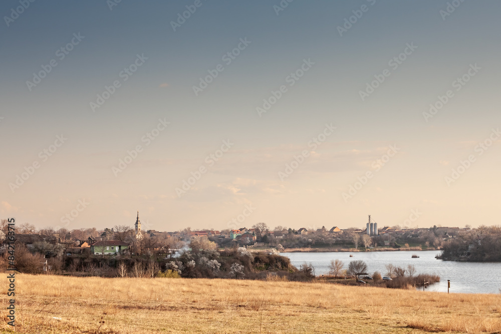 Obraz premium Panorama of the Village of Deliblato in Serbia with lake kraljevac in front at dusk. Deliblato is a serbian village of vojvodina known for its natural reserve, deliblatska pescara.