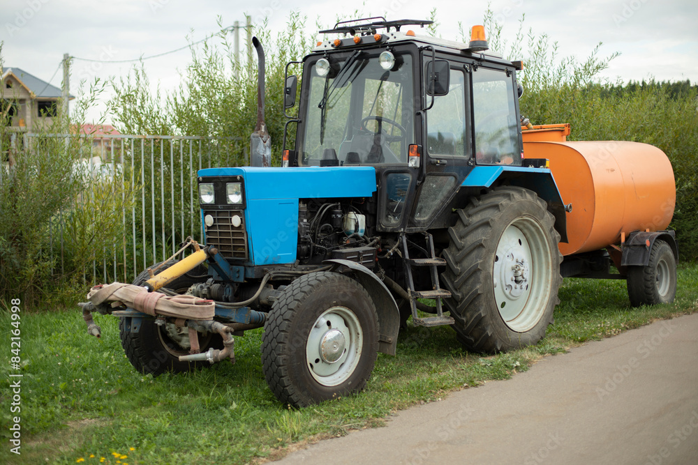 Obraz premium Tractor with water. Tractor equipped with system water irrigation. Agricultural machinery.
