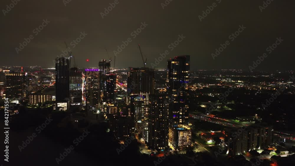 Dynamic night time aerial view of Austin's downtown skyline, capturing the glowing city lights and lively urban scenery Dynamic night time aerial view of Austin's downtown skyline, capturing the glowing city lights and lively urban scenery