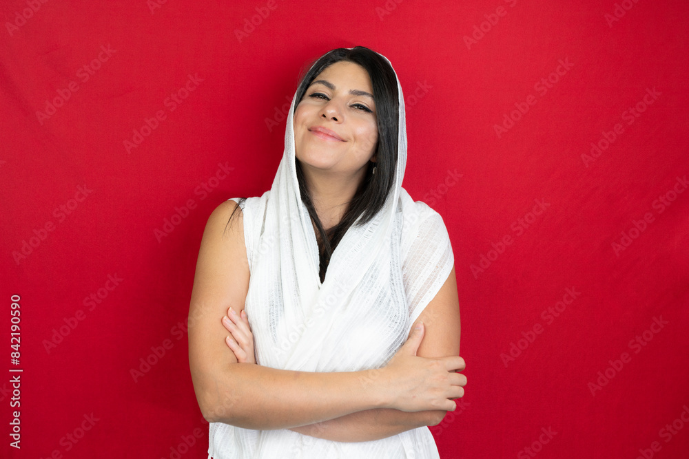 Portrait of a woman with a white scarf in the studio. middle eastern young woman red background Portrait of a woman with a white scarf in the studio. middle eastern young woman red background