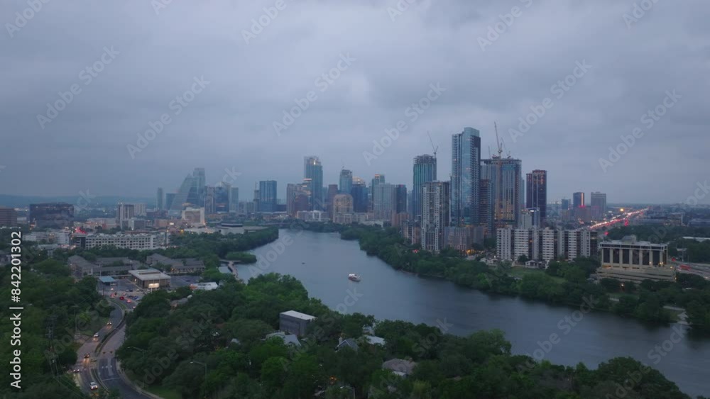 Austin's skyline from above, featuring tall buildings and the colorado river under a cloudy sky. Urban beauty of the cityscape