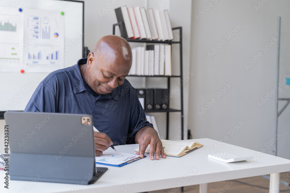 Creative african businessman senior american worker using computer device in office,chat online, thinking business solution planning difficult decision pondering strategy come up with idea. Creative african businessman senior american worker using computer device in office,chat online, thinking business solution planning difficult decision pondering strategy come up with idea.