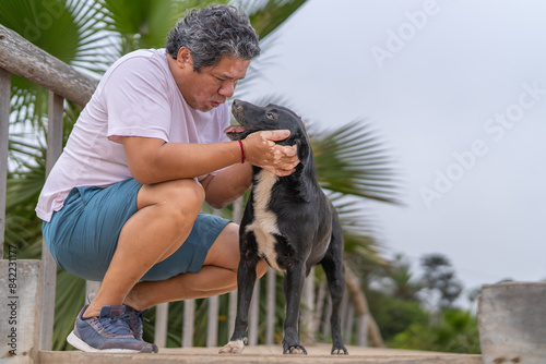 Man with vitiligo and his cute dog in a park