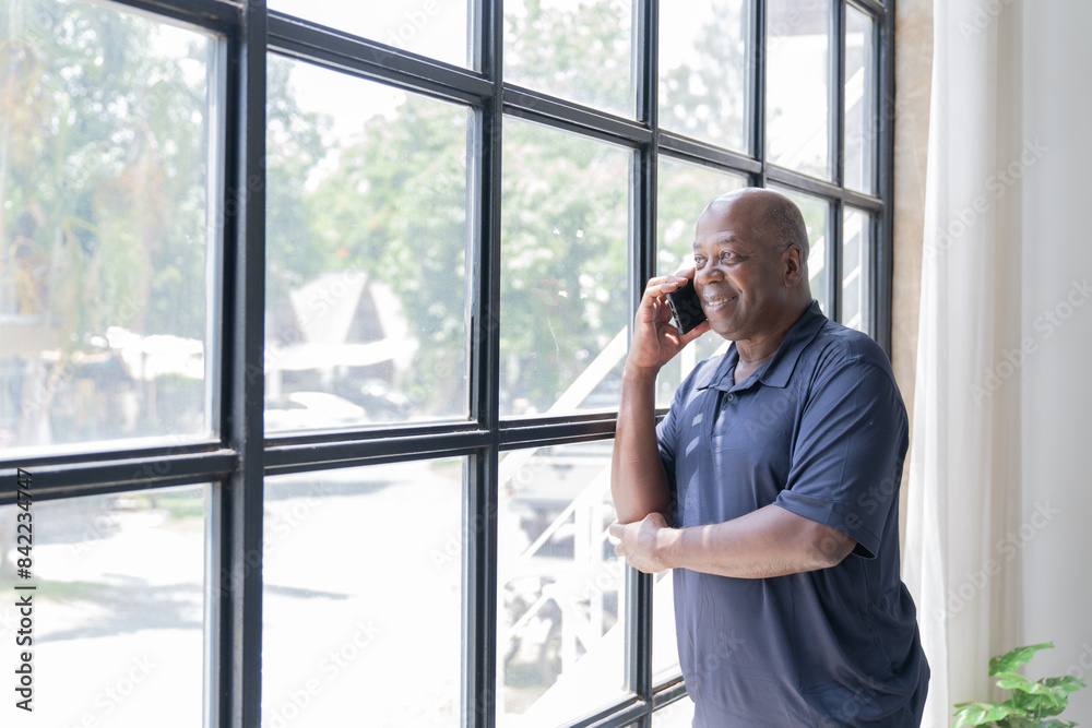 Portrait of happy African American small business owner. Millennial black smiling, sitting and using the laptop, and holding a cup of coffee work in modern office. Portrait of happy African American small business owner. Millennial black smiling, sitting and using the laptop, and holding a cup of coffee work in modern office.
