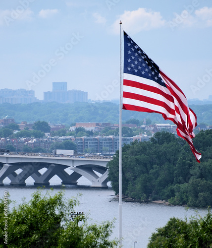 American flag in front of a cityscape
