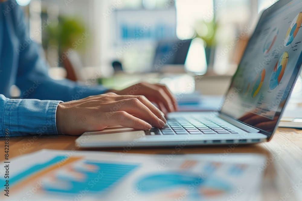Focused on Business: Hands Typing on Laptop with Charts and Graphs. Focused on Business: Hands Typing on Laptop with Charts and Graphs.