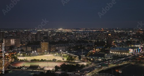 Wallpaper Mural NYC New York Aerial v261 drone flyover Bronx capturing sports field, retail complex, traffics on Macombs Dam expressway and cityscape of Mott Haven at night - Shot with Inspire 3 8k - September 2023 Torontodigital.ca