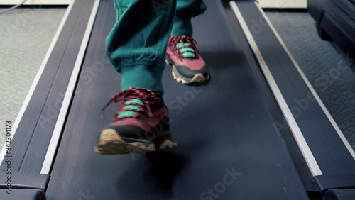 front view of a person walking on a treadmill
