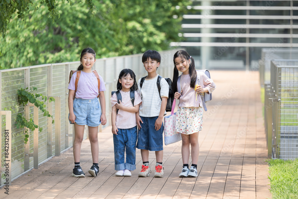 Full body of smiling Japanese elementary school student looking at camera going to school Multiple wide angles Full body of smiling Japanese elementary school student looking at camera going to school Multiple wide angles