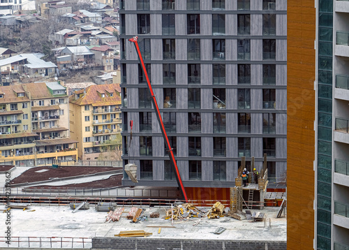 Construction Site. Modern Buildings development. Old houses on background