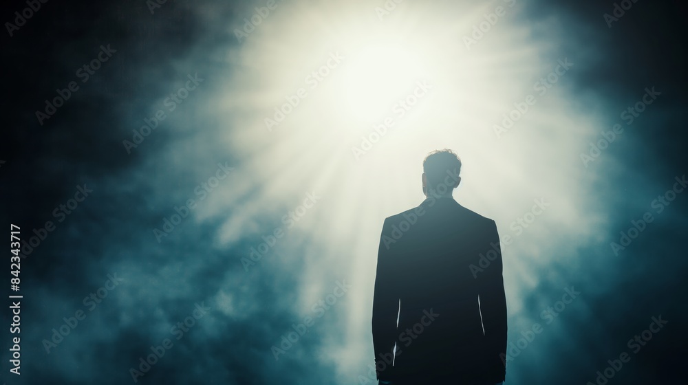 A silhouette of a man standing with a halo of light behind him, creating a mood of inspiration or revelation A silhouette of a man standing with a halo of light behind him, creating a mood of inspiration or revelation