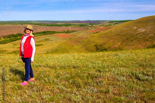 beautiful mature women walking in the spring hills on a sunny day © tramp51