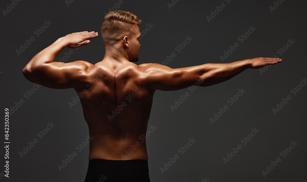 Back, stretching and bodybuilder in studio for exercise, training and ...