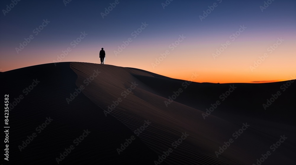 A solitary figure wanders across endless desert dunes under twilight, a silhouette against the fading light. A solitary figure wanders across endless desert dunes under twilight, a silhouette against the fading light.