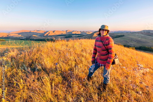 portrait of a beautiful mature woman traveling through the mountains of the Southern Urals on a summer sunny day photo
