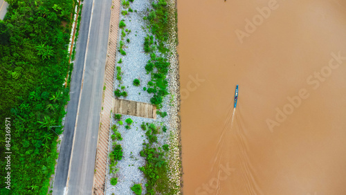 Aerial view of beautiful view of the mighty Mekong River with fishing boats passing by at the border of Thailand and Laos, Chiang Rai Province, Thailand.