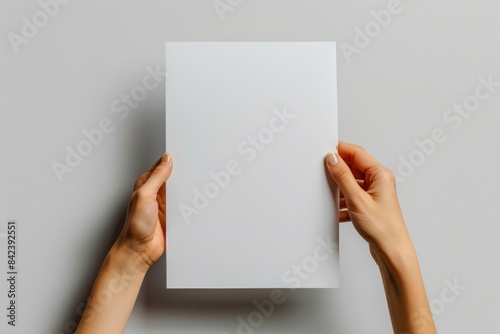 Blank paper mockup on hand created with generative AI © dendyh7
