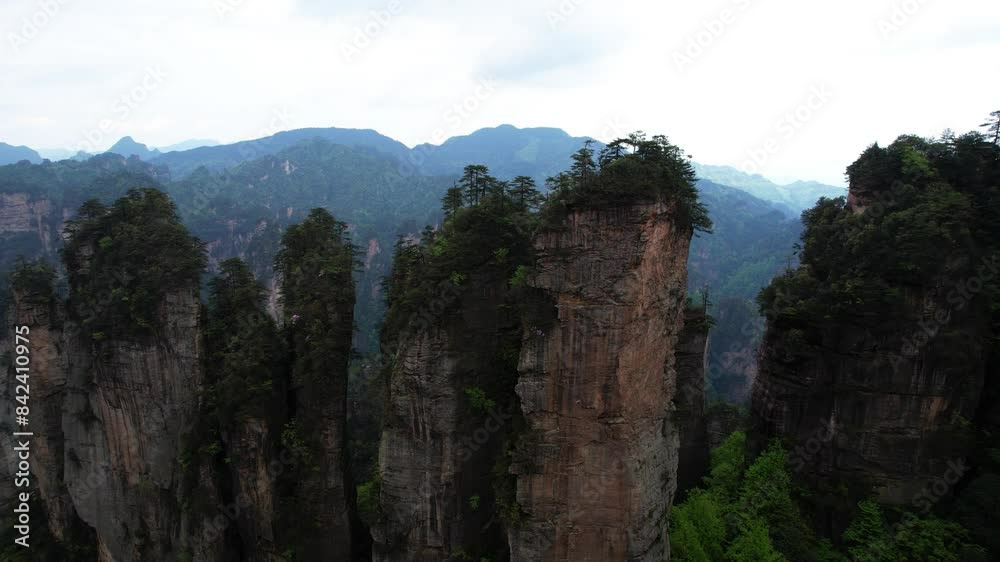 Aerial descent at Five Finger Peak, huge stone pillars by Huangshi Village at Zhangjiajie National Forest Park, China Aerial descent at Five Finger Peak, huge stone pillars by Huangshi Village at Zhangjiajie National Forest Park, China