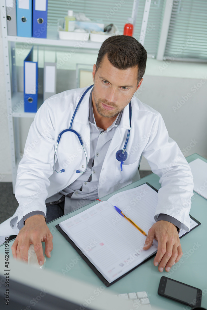 young male doctor in office young male doctor in office