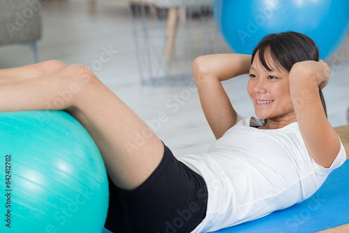 pilates woman with ball exercise workout at gym indoor