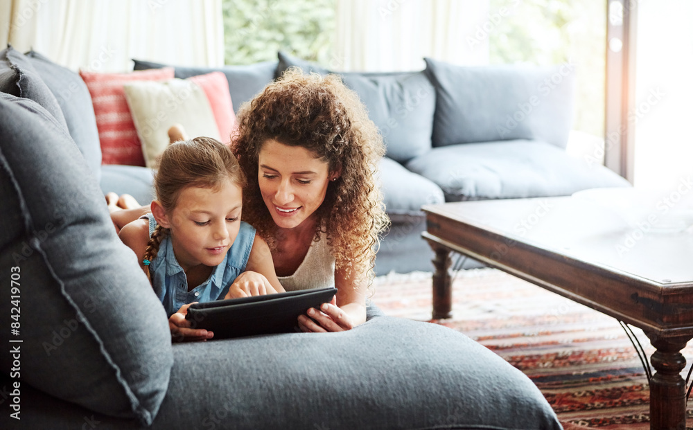 Woman, tablet and kid in watching as family on weekend, break at home for online gaming or movies. Calm, people and lounge for relax, together and bonding as parent for growth, development or love