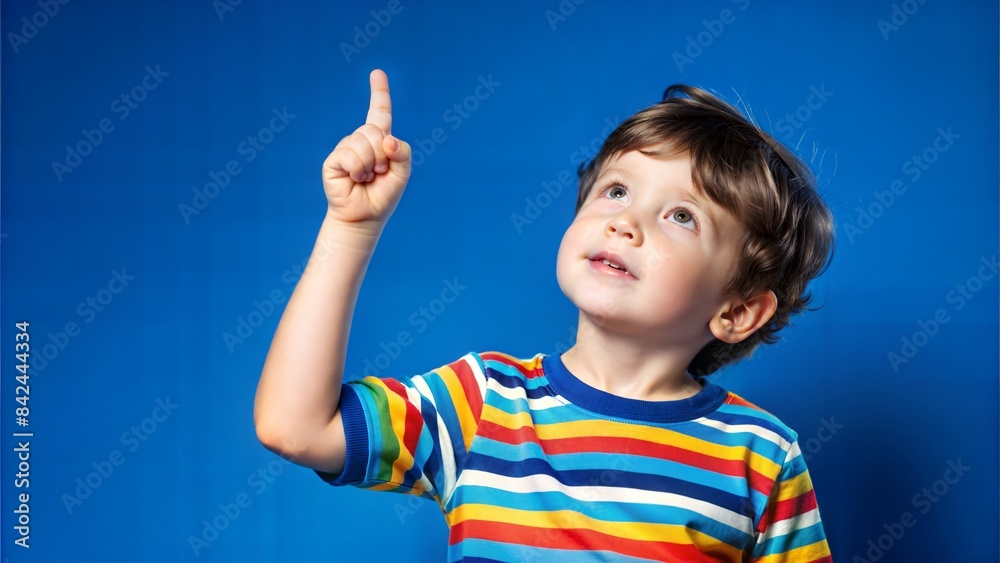 The boy points his index finger upward, expressing the state of a good idea. The boy points his index finger upward, expressing the state of a good idea.