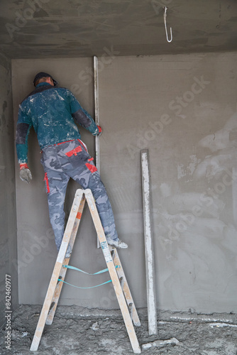 Plastering of plaster workers on the walls for building. © denfotoblog