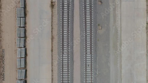 The construction of the unfinished railway line, a lot of stones on the side of the tracks. photo