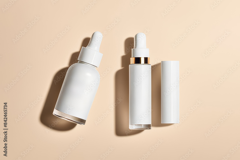 Top view of different skin care products. Cream and serum, emulsion in white glass packaging on beige background. Unbranded mockup. AI Generative Top view of different skin care products. Cream and serum, emulsion in white glass packaging on beige background. Unbranded mockup. AI Generative