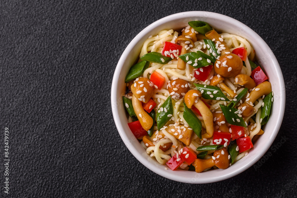 Delicious Asian cuisine dish with rice noodles, peppers, mushrooms and spices Delicious Asian cuisine dish with rice noodles, peppers, mushrooms and spices