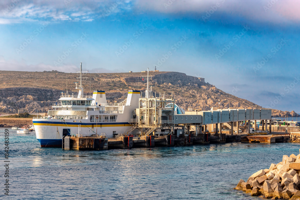 Malta to Gozo, Passengers board modern ferry at Cirkewwa Passenger terminal for scenic cruise to idyllic Gozo Island. Malta travel destination. Malta to Gozo, Passengers board modern ferry at Cirkewwa Passenger terminal for scenic cruise to idyllic Gozo Island. Malta travel destination.