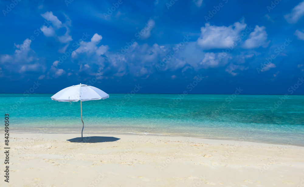 Summer tropical with white umbrella on the beach with blue sky background Summer tropical with white umbrella on the beach with blue sky background