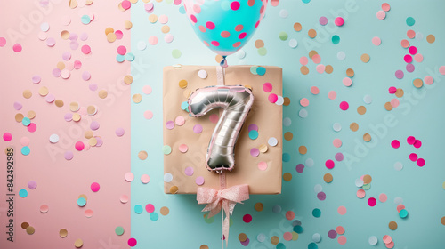 The seventh birthday is a special day, so a gift in an elegant box with a balloon in the shape of the number 7, colorful confetti and bows on a delicate background of pastel colors