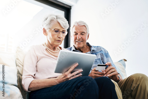 Senior couple, tablet and credit card with browsing in house for online shopping with people. Finance, retirement and discount with internet banking, transaction and digital purchase in home.