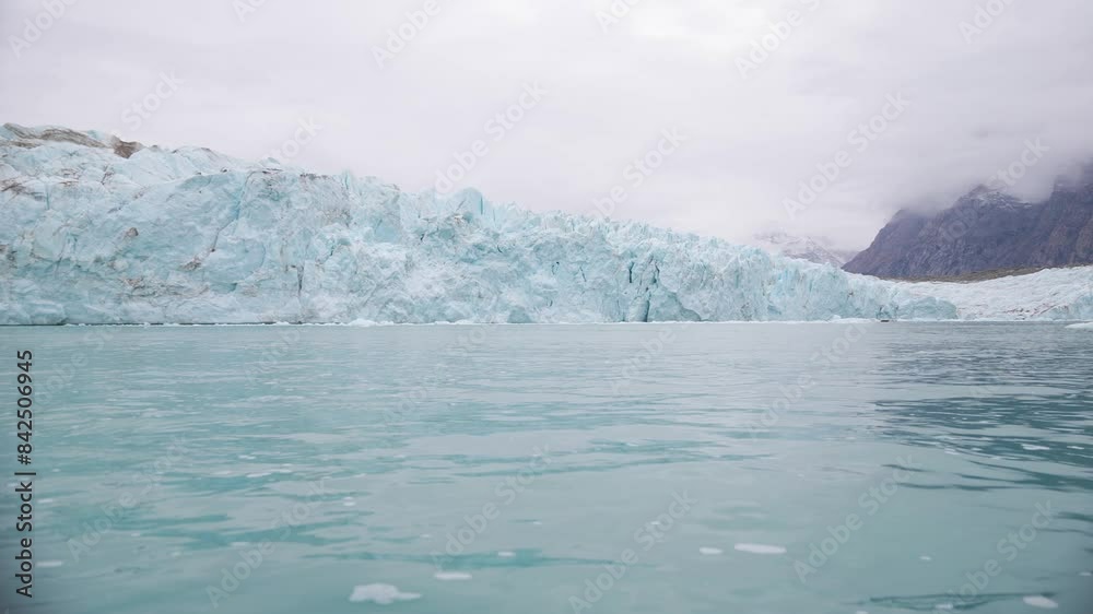 Glacier and Cold Arctic Sea, Boat Passenger POV. Alpefjord, Greenland Glacier and Cold Arctic Sea, Boat Passenger POV. Alpefjord, Greenland