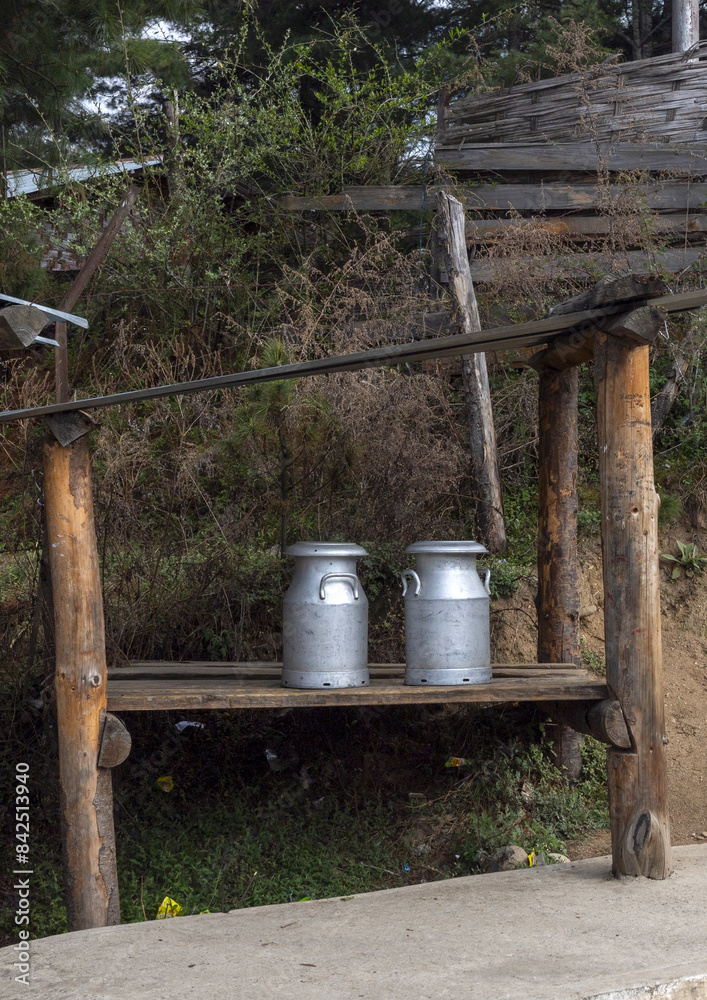 Milk churns along the road, Chhoekhor Gewog, Bumthang, Bhutan Milk churns along the road, Chhoekhor Gewog, Bumthang, Bhutan