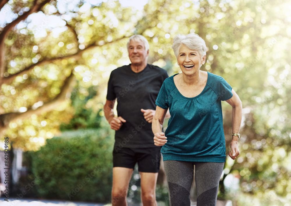 Running, outdoor and senior couple with exercise, wellness and bonding together with challenge. People in park, old man and mature woman with training, retirement and hobby with sunshine and healthy Running, outdoor and senior couple with exercise, wellness and bonding together with challenge. People in park, old man and mature woman with training, retirement and hobby with sunshine and healthy