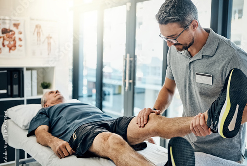 Фотография Physiotherapist, senior man and stretching leg for knee pain, medical and consultant with injury support