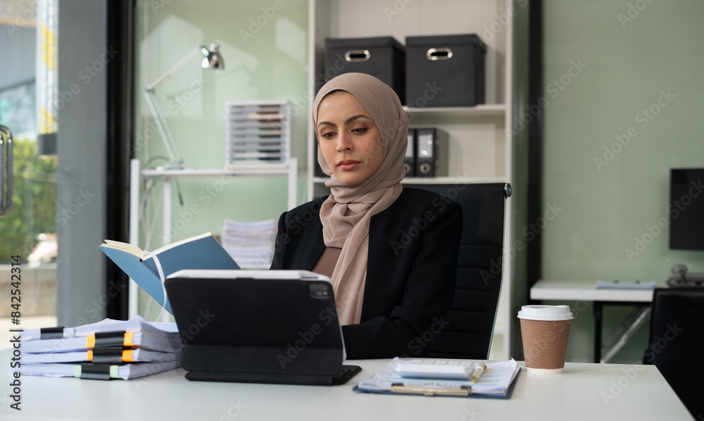 Successful business woman using laptop computer and smartphone in office. Happy woman, entrepreneur, small business owner working online. Successful business woman using laptop computer and smartphone in office. Happy woman, entrepreneur, small business owner working online.