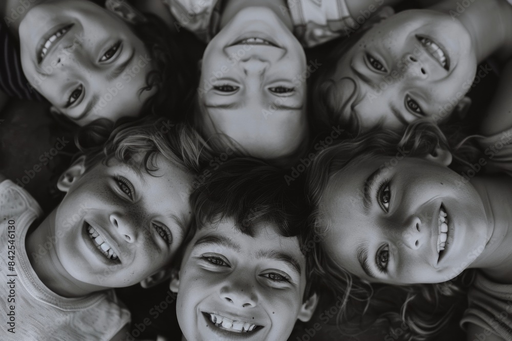 Group of children smiling and looking at the camera. Black and white. Group of children smiling and looking at the camera. Black and white.