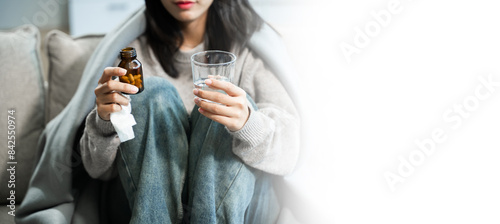 woman holding bottle with pills on hand going to take medicaments prescribed by his physician © Nuttapong punna