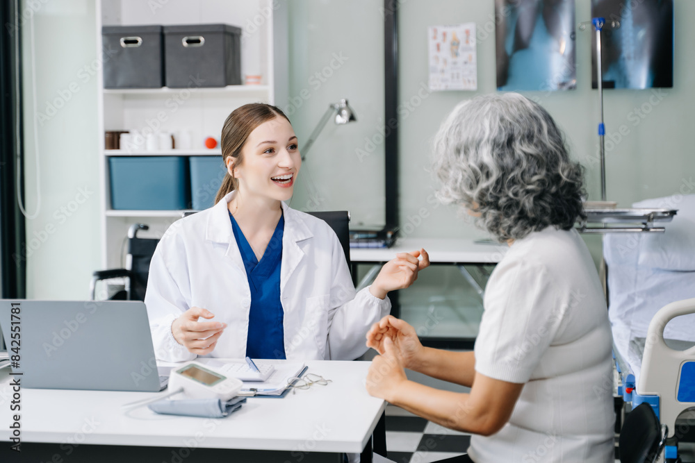 Obraz premium Portrait of female doctor explaining diagnosis to her patient. Doctor Meeting With Patient In Exam Room. A medical practitioner reassuring a patient .