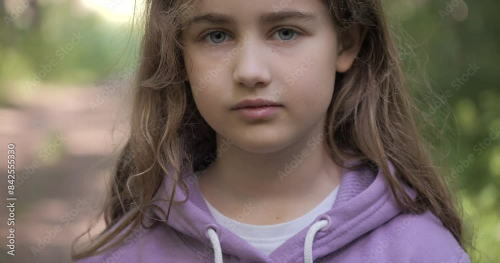 Portrait Child Girl Looking at Camera Standing on Street in City on Summer Day. Sad Thinking Curiosity Teenager Looking at Camera Closeup Outdoors. Human Face Eyes Serious Contemplative Child. Portrait Child Girl Looking at Camera Standing on Street in City on Summer Day. Sad Thinking Curiosity Teenager Looking at Camera Closeup Outdoors. Human Face Eyes Serious Contemplative Child.